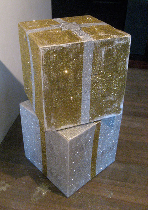 Regalos (Gold) and Regalos (Silver) (installation view at Green
		  Papaya Art Projects, Quezon City, Philippines), 2007, balikbayan boxes,
		  glue, glitter, shipped from San Francisco, California, USA to Manila,
		  Philippines, 18 x 18 x 18 inches / 46 x 46 x 46 cm. each. Photo courtesy
		  Stephanie Syjuco.