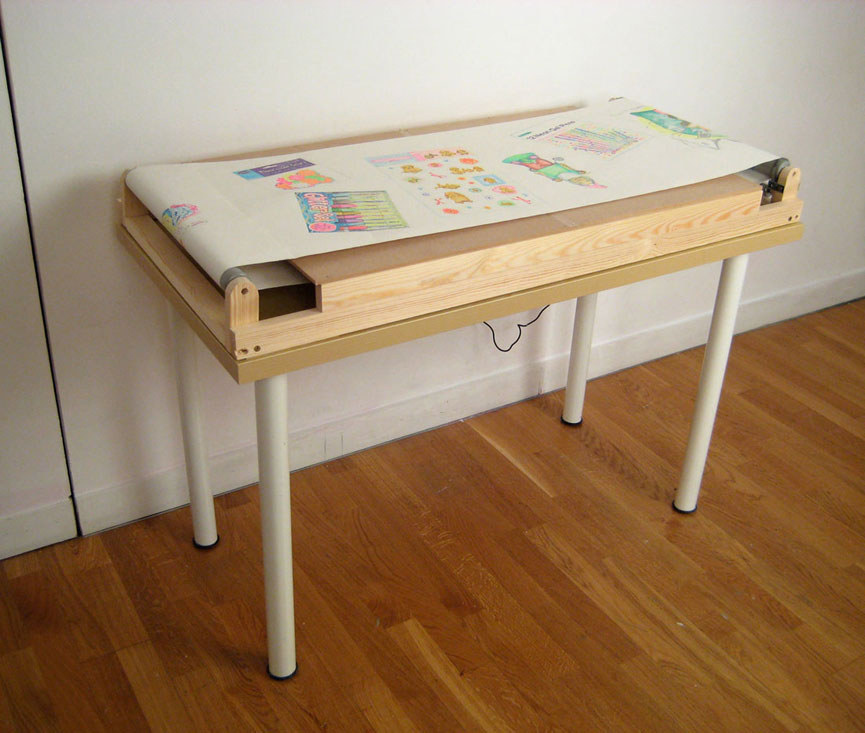 Pounds of Happiness (conveyor belt), 2009, paper, neon gel
          pens, glitter pens, wood, motor, table, 48 x 34 x 24 inches / 122 x
        86 x 61 cm