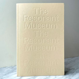 the resonant museum book cover, with the title debossed three times in a cream yellow cover