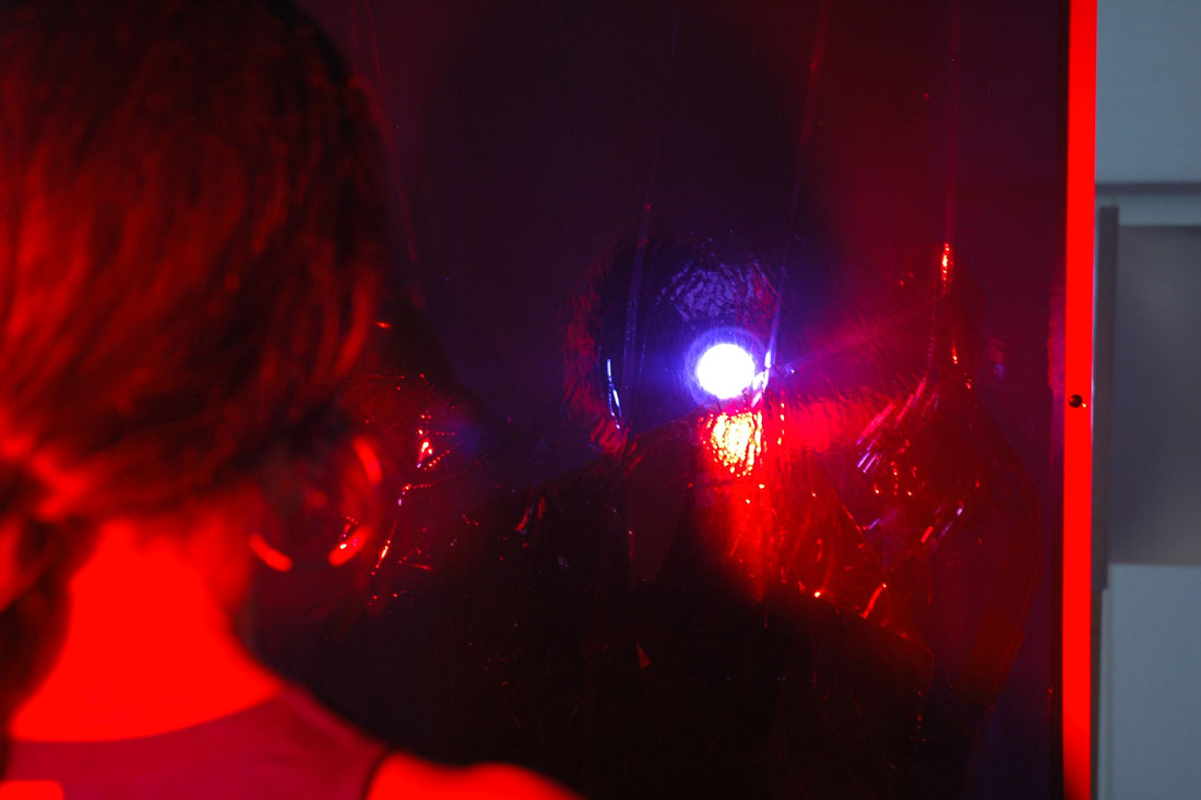 Doorway (interaction view detail), 2014, wood, vinyl, asphalt-based coating, lights, stands, gels, door: 82.5 x 33.5 x 5.5 inches / 210 x 85 x 14 cm