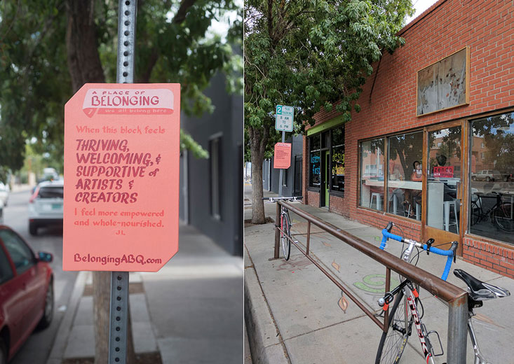 image of belonging sign #1 at 2nd Street SW, in front of a coffee house and bike rack. Text of the sign: 'A Place of Belonging #1, we all belong here. Thriving, welcoming, and supportive of artists and creators. I feel more empowered and whole-nourished. JL. BelongingABQ.com'