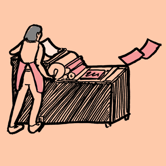 person printing on a letterpress