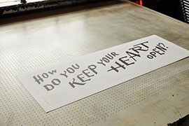 Photo of a fine art print on a vacuum screenprinting table.
