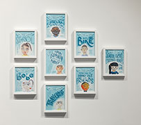 A group of drawings in blue with calligraphy around children's self-portraits.