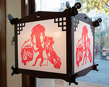Lantern with papercut in red with a figure under various pressures