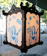 Lantern with a woman shouting into a bullhorn at City Hall