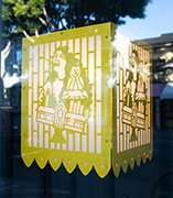 A lantern of yellow inspired by papel picado featuring a woman shouting over a student looking sad.