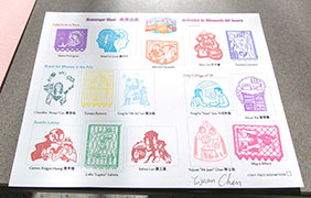 a sheet of white paper with 15 colorful rubber stamps on it