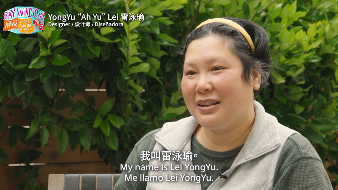 still of trilingually subtitled video interview with a woman, available at the link