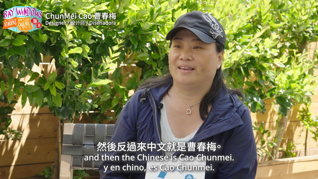 still of trilingually subtitled video interview with a woman, available at the link